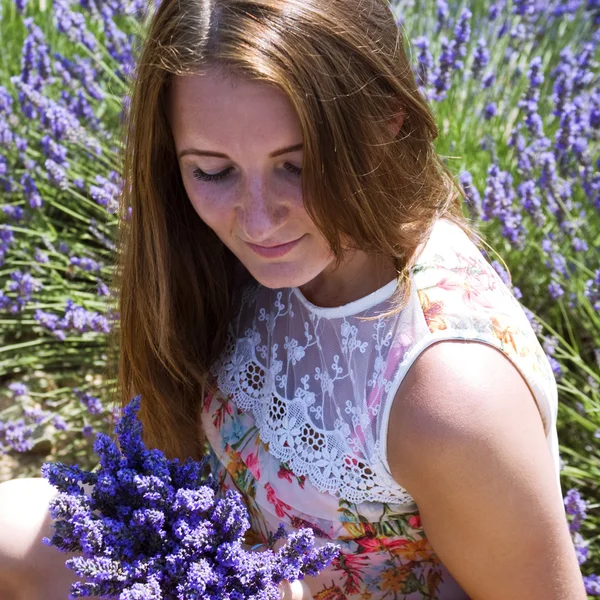 Ung kvinna poserar i lavendel fält — Stockfoto