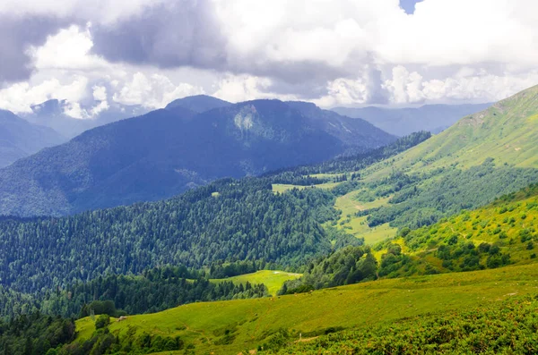 Lindas montanhas ensolaradas de verão com nuvens e prados — Fotografia de Stock