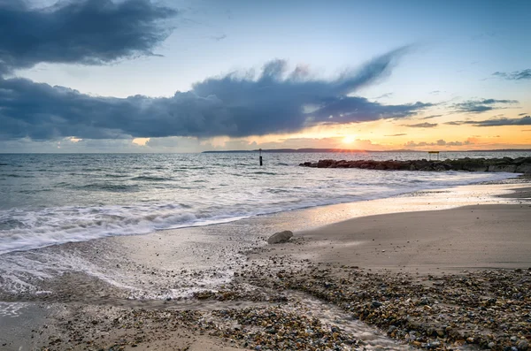 Solent Beach solnedgang - Stock-foto