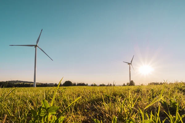 Wind mill industrial energy farm against blue sky with sun — Stock Photo, Image