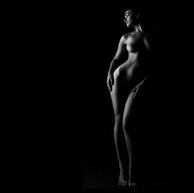 Kadın bedeni koyu arka plan üzerinde kıvrımlarına. Seksi vücut çıplak