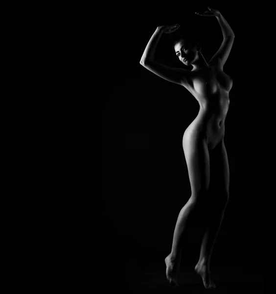 Contornos del cuerpo femenino sobre un fondo oscuro. Sexy cuerpo desnudo —  Fotos de Stock