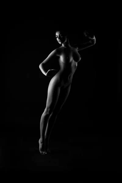 Contornos del cuerpo femenino sobre un fondo oscuro. Sexy cuerpo desnudo —  Fotos de Stock