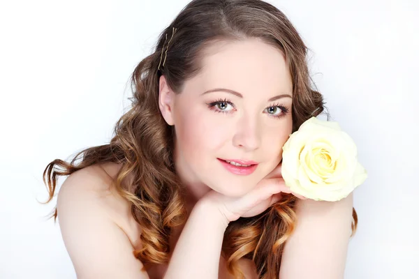 Beautiful young woman with pink rose — Stock Photo, Image