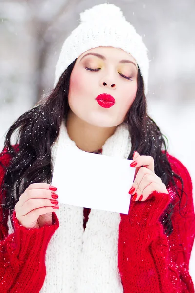 Mooi jong meisje houdt een postkaart met tekst "Kiss me" — Stockfoto