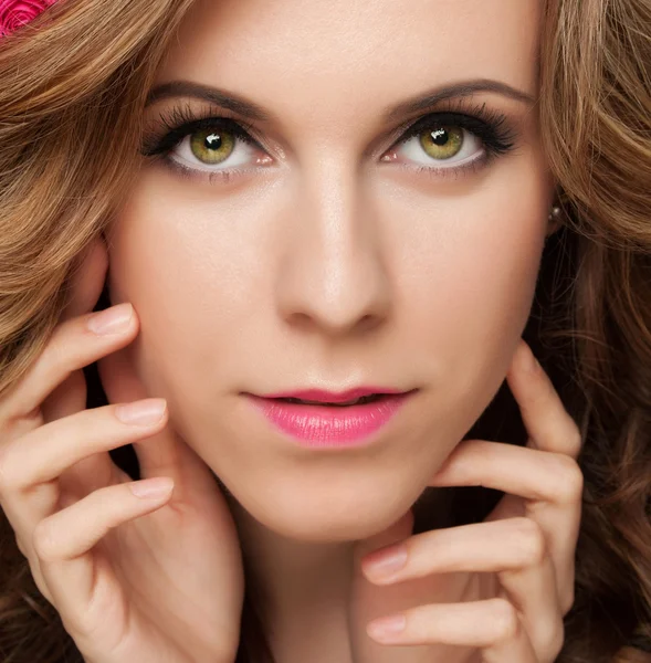 Beautiful young woman with delicate flowers in their hair — Stock Photo, Image