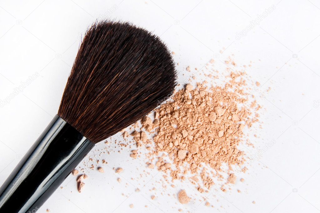 Makeup brushes and powder in motio