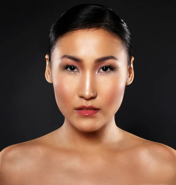 attractive asian woman skin care image on black backgroun