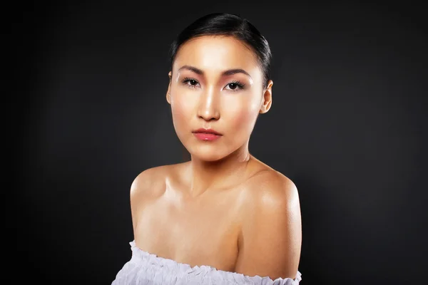 attractive asian woman skin care image on black backgroun