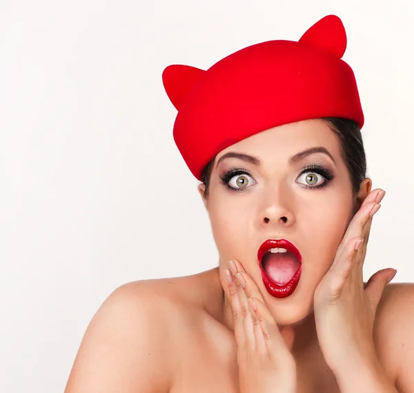 Charming and flirting girl in a funny red hat, the image of a pl — Stock Photo, Image