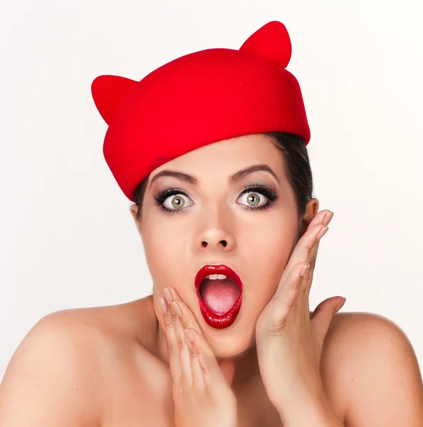 Charming and flirting girl in a funny red hat, the image of a pl — Stock Photo, Image