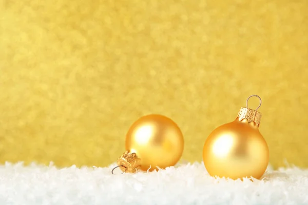 Christmas gold balls on gold glitter background. Top view