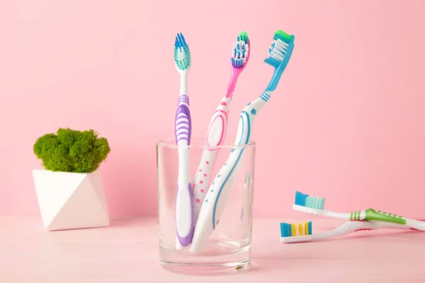 Toothbrushes Glass Pink Background Tools Oral Care Top View — Stock Photo, Image