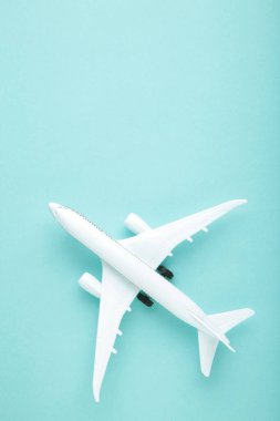 Mavi pastel arka planda model uçak. Seyahat kavramı
