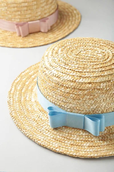Top view of straw beach hats with different ribbon. Top view