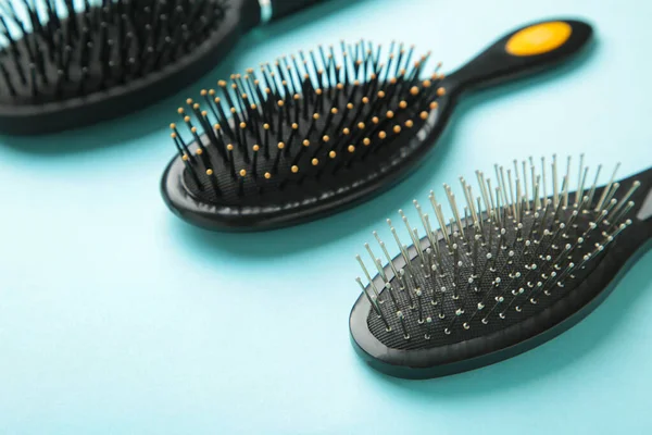 Hair tools, beauty and hairdressing concept - different brushes or combs on blue background