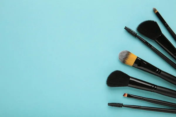 Various Makeup Brushes Blue Background Copy Space Top View — Stock Photo, Image