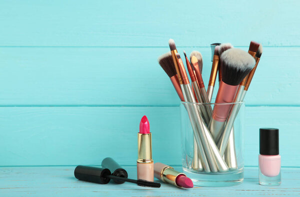 Set of make-up products on blue background. Top view