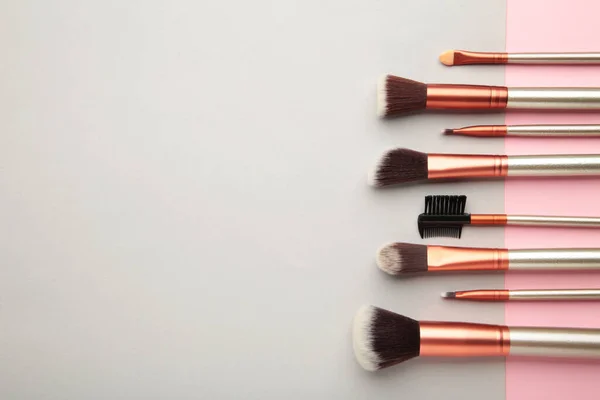 Various Makeup Brushes Grey Pink Background Copy Space Top View — Foto de Stock