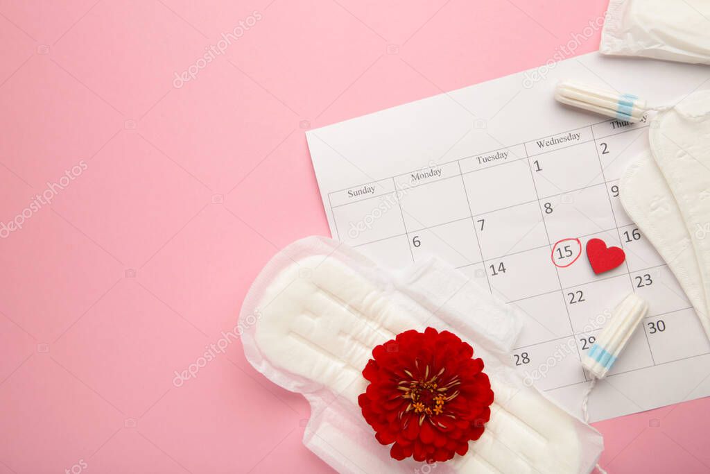 Menstruation calendar with cotton tampons and pads. Woman critical days, woman hygiene protection. Top view