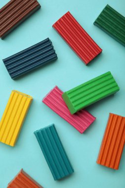 Mavi arka planda çok renkli plastik tuğlalar. Çocuklar plastiklere yakın çekim.