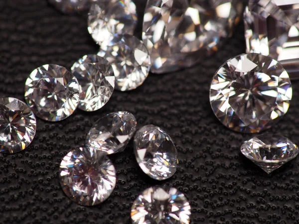 Close up shoot of group of sparkling diamonds, shoot on black leather as background