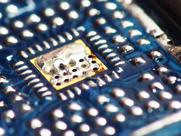 Close up shoot of Surface Mount Device (SMD) parts such as IC, micro chips, processors, led, resistor, capacitor, camera module, etc. soldered on Printed Circuit Board (PCB)