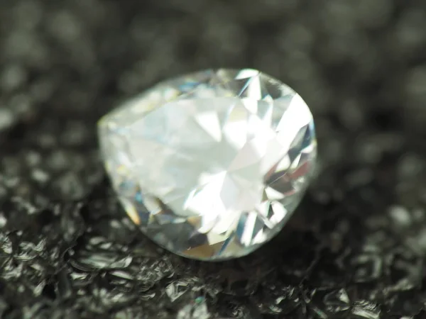 Close up shoot of pear shape diamond. Capture on black background.