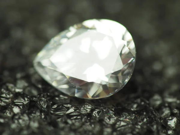Close up shoot of pear shape diamond. Capture on black background.