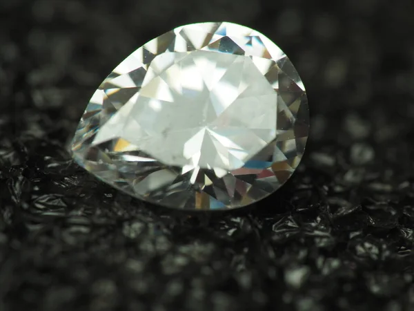 Close up shoot of pear shape diamond. Capture on black background.