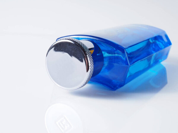Close up shoot of blue perfume bottle. Shoot on white isolated background