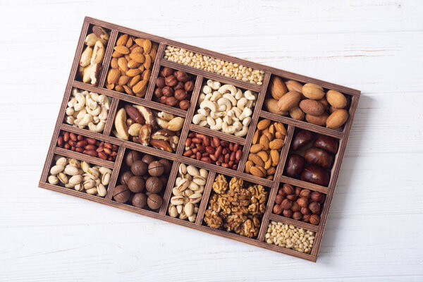 Mix of nuts in box . Healthy vegetarian food background photo