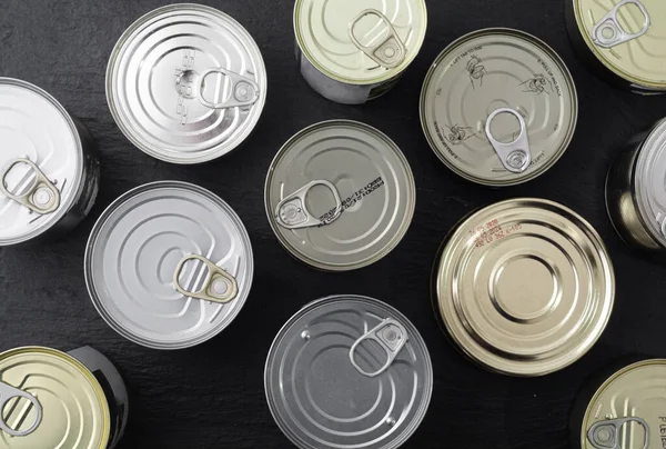 Tin silver cans for tinned food on wooden background