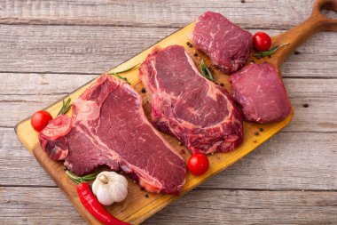 Çiğ biftek çeşitleri. T-bone, pirzola ve fileminyon. Gıda arkaplanı