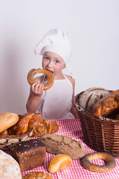 Little chef with many kind of bread — Stock Photo, Image
