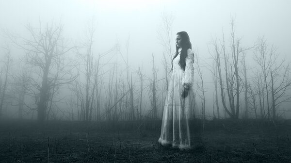 Haunted female ghost in the spooky forest