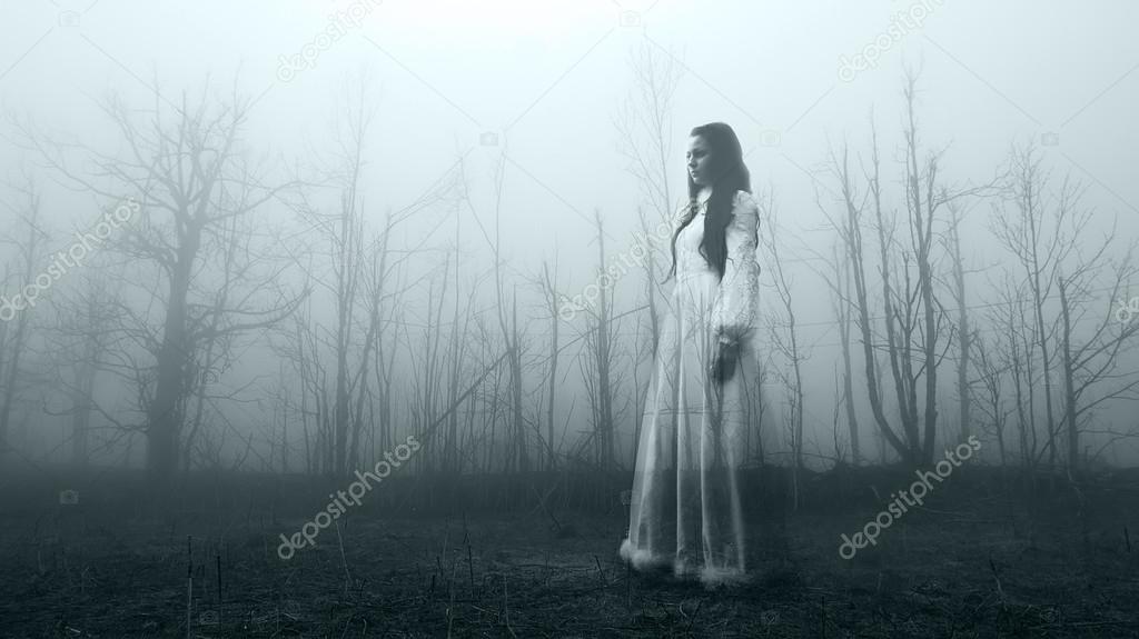 Horror woman in the foggy forest