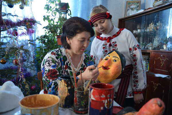 Vashkivtsi, Chernivtsi Oblast, Ukraine - 14.01.2013: Ukrainian craftswomen decorate the mask for Malanka holiday.