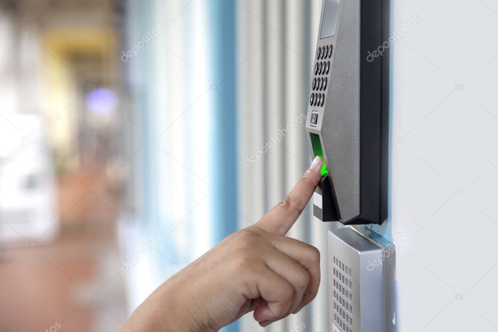 Close up hand of asian woman scanning fingerprint electronic digital door lock security system