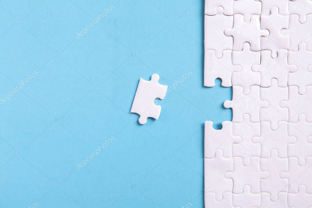 Unfinished jigsaw puzzle on blue background with copy space for your text or content , Working concepts separated from groups