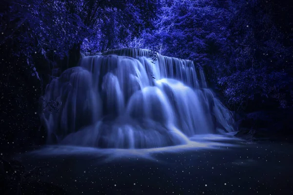 Beautiful waterfall nature scenery of colorful at a night deep tropical fantasy jungle