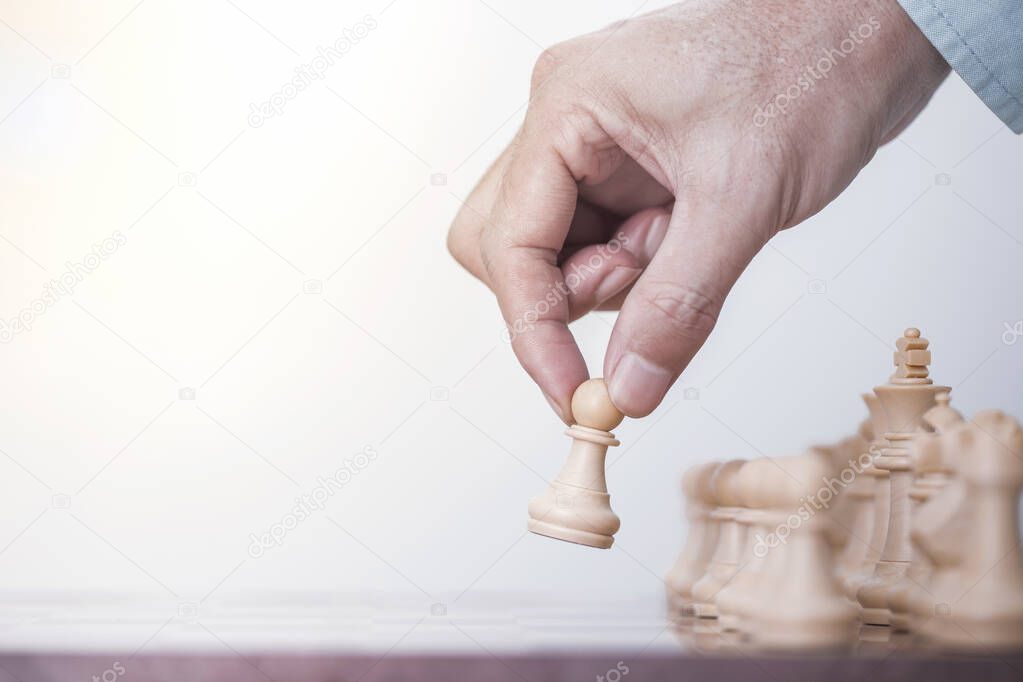 Businessman play with chess game in competition success play, concept strategy and successful management or leadership