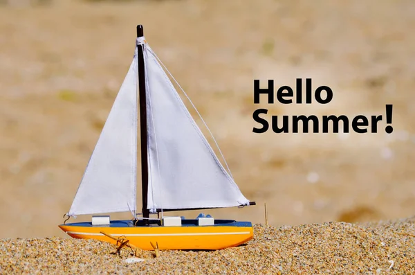 Hello Summer Greeting Card with Toy Boat on the Beach . Summer Sea Vacation Concept