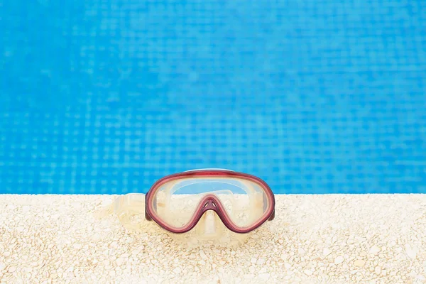 Diving mask on the side of the pool. Summer. Active lifestyle.
