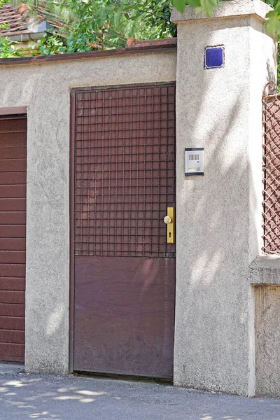 Brown door house gate with intercom bell