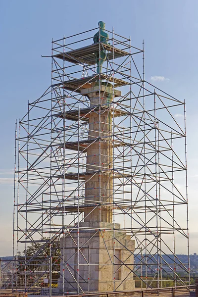 Column pillar monument landmark scaffolding structure construction site