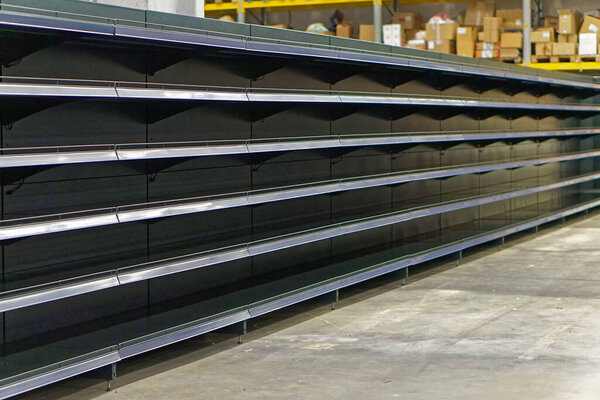 Empty long shelf in grocery store food shortages problems
