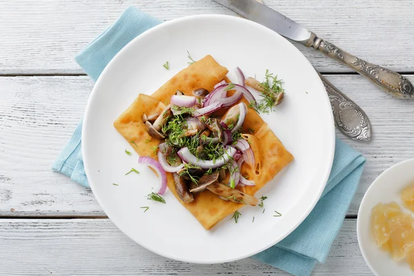 Pancakes with mushrooms on plate — Stock Photo, Image