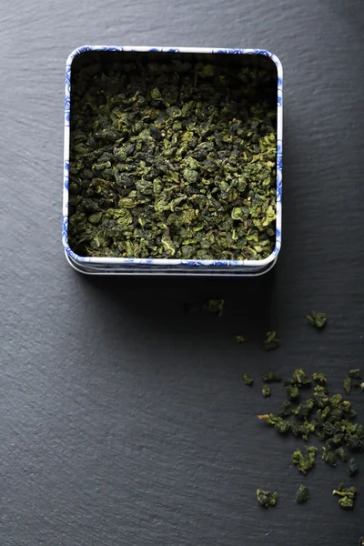 Green tea leaves in box — Stock Photo, Image