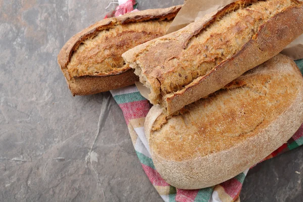 Fresh breads on rustic napkin — Stock Photo, Image